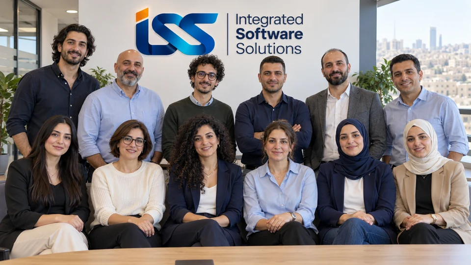 Group portrait of twelve people in an office with Integrated Software Solutions logo signage